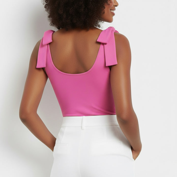 Back view of woman wearing a Hot Pink bow-shoulder bodysuit from Motch, part of a matching mommy-and-me outfit set, highlighting the smooth fit and elegant bow detail.