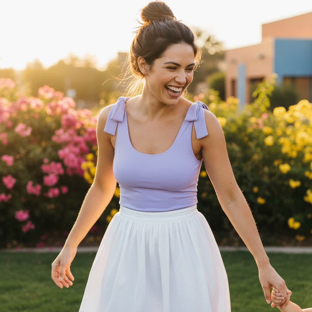 Woman wearing a lavender one-shoulder bodysuit by Motch